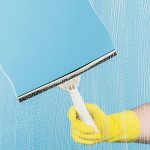cleaning window with squeegee