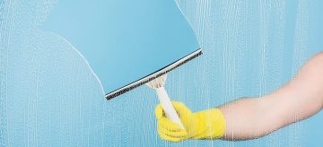 cleaning window with squeegee