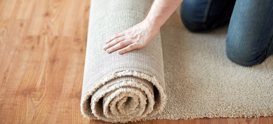 person rolling a new carpet