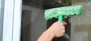 washing outside window with mop