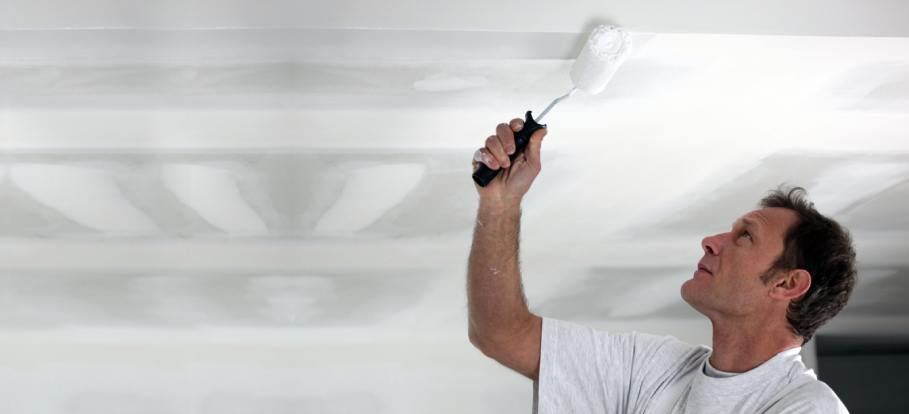 Professional painter working on a newly-plastered ceiling