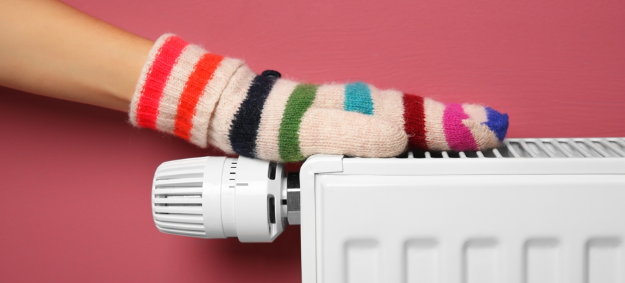 Central heating - hand in mitten on radiator