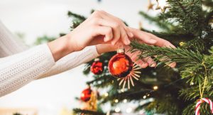 Woman decorating a Christmas tree