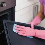 Woman cleaning oven tray