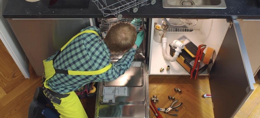 technician installing a dishwasher