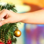 woman decorating christmas tree