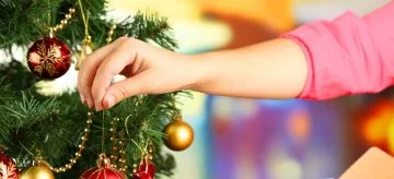 woman decorating christmas tree