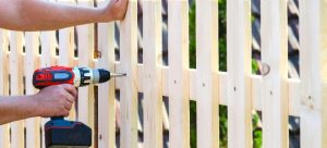 hands building garden fence