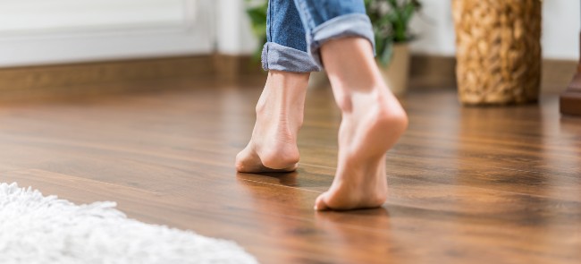 woman walking on wooden floor