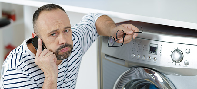 Man is calling a technician for washing machine error code