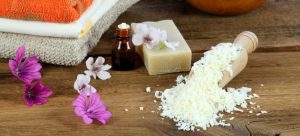 Bar of soap, essential oil and grated soap necessary for homemade eco-friendly laundry detergent.