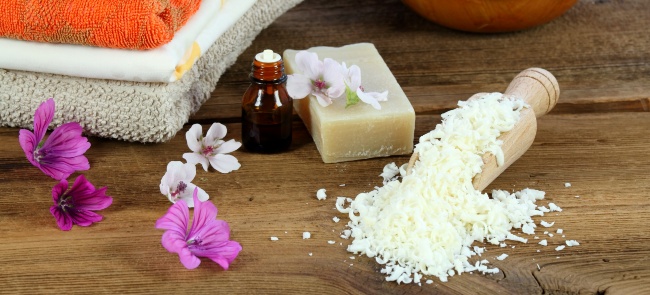 Bar of soap, essential oil and grated soap necessary for homemade eco-friendly laundry detergent.