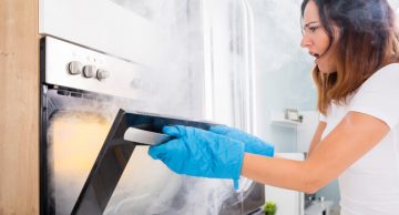 Woman with a smoking oven