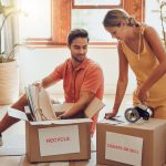 Man and woman saving space when packing