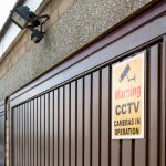 Garage door with CCTV warning