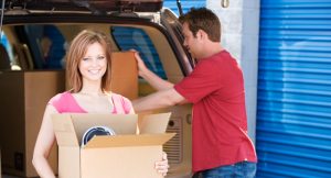 Couple moving their belonging into storage unit