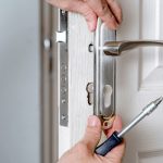 Man fixing a multipoint door lock problem