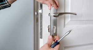 Man fixing a multipoint door lock problem