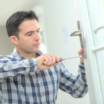 Man changing a door handle