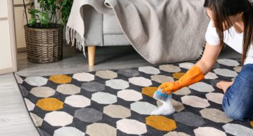 Woman cleaning rust stain on carpet