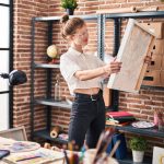 Woman considering where to store her paintings