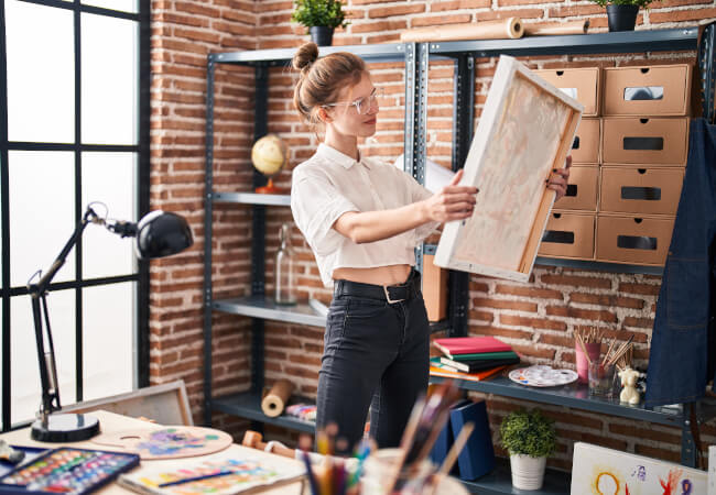 Woman considering where to store her paintings