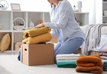 Woman going through stored clothes and items