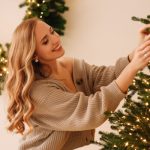 Woman decorating a big Christmas tree