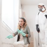 Woman showing mould infestation to a professional