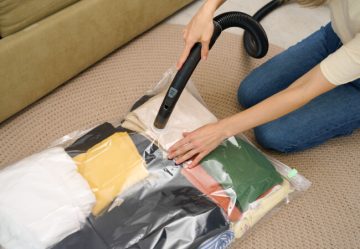 Woman storing clothes in vacuum storage bags