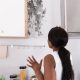 Woman looking at mould on kitchen wall