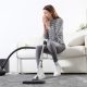 Woman sneezing while cleaning the carpet