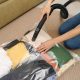 Woman storing clothes in vacuum storage bags