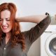 noisy washing machine when spinning and frustrated woman