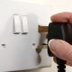 hand putting plug in electric socket