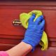 person cleaning wooden furniture