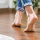 woman walking on wooden floor