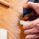 person repairing laminate flooring