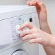 Person choosing settings on washing machine