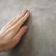 hand touching rough wall