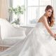 Woman in luxurious wedding dress sitting on a sofa